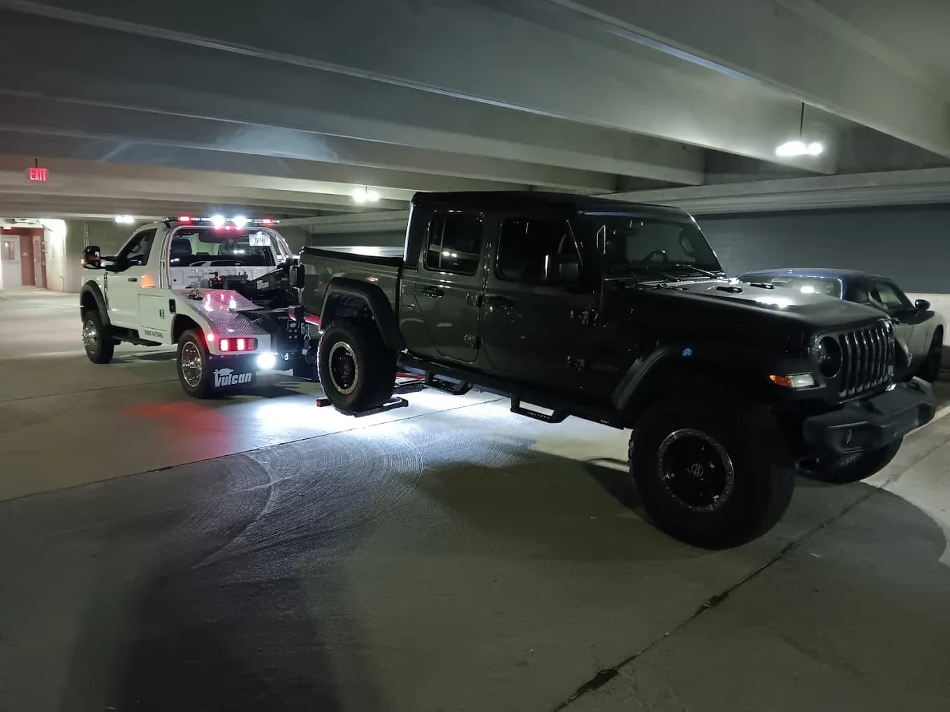 Self-loader removing a vehicle from a parking garage
